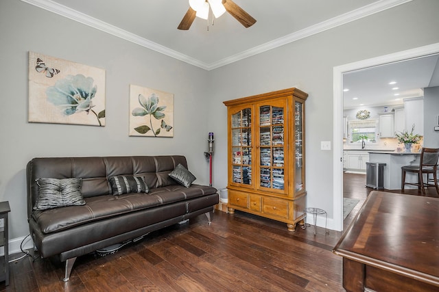 living room featuring crown molding, dark wood-type flooring, and ceiling fan