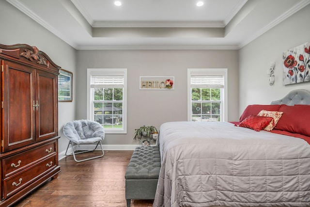 bedroom featuring crown molding, dark wood-type flooring, and a tray ceiling