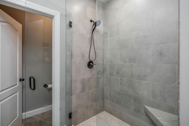 bathroom with a shower with shower door