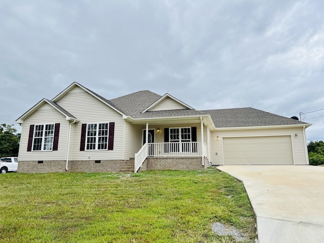 ranch-style home with a front lawn, a garage, and covered porch