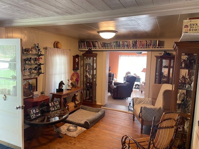 interior space with hardwood / wood-style flooring and wood walls