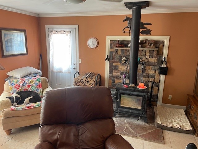 tiled living room featuring a wood stove and crown molding