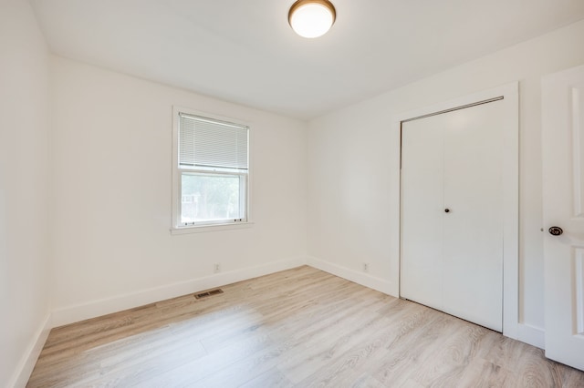 spare room featuring light hardwood / wood-style floors