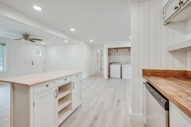 kitchen featuring stainless steel dishwasher, light hardwood / wood-style flooring, butcher block countertops, and white cabinetry