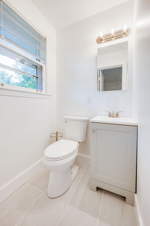 bathroom featuring vanity, toilet, and tile patterned floors