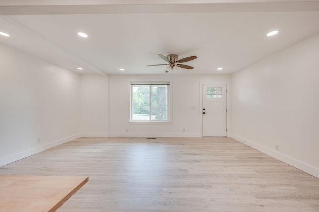 spare room with ceiling fan and light wood-type flooring