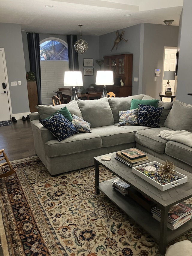 living room featuring hardwood / wood-style flooring and a notable chandelier