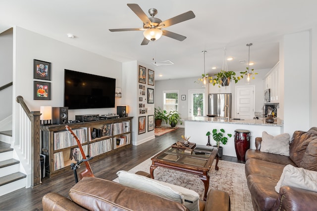 living room with ceiling fan, dark wood-type flooring, and sink