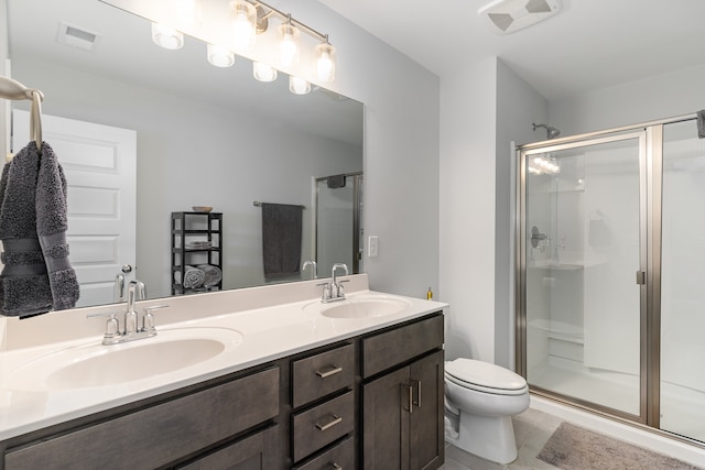 bathroom with tile patterned flooring, vanity, toilet, and walk in shower