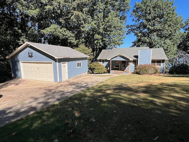 view of front of property featuring an outdoor structure, a garage, and a front lawn