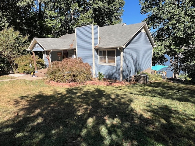 view of front of house with a chimney and a front lawn