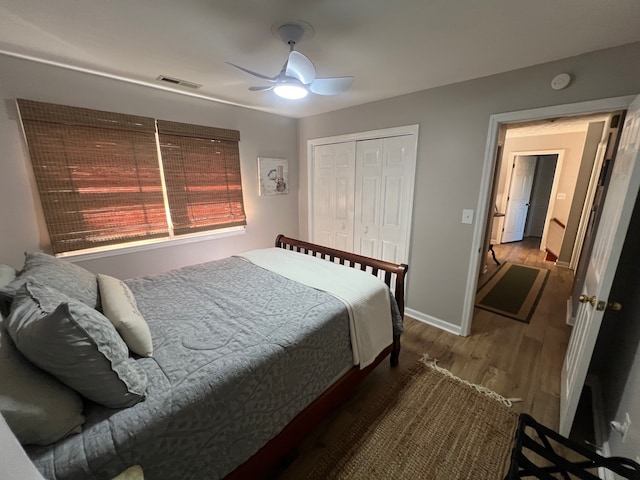 bedroom with wood-type flooring, ceiling fan, and a closet