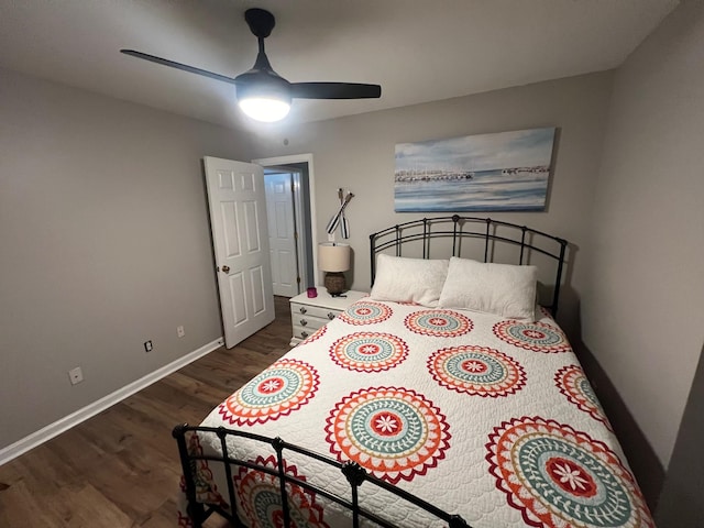 bedroom featuring baseboards, wood finished floors, and a ceiling fan