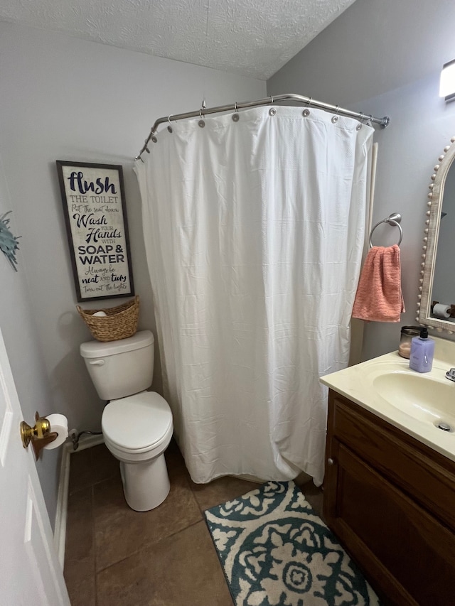 bathroom featuring tile patterned flooring, walk in shower, toilet, vanity, and a textured ceiling