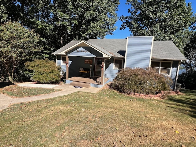 view of front of home featuring a front lawn, covered porch, and a chimney