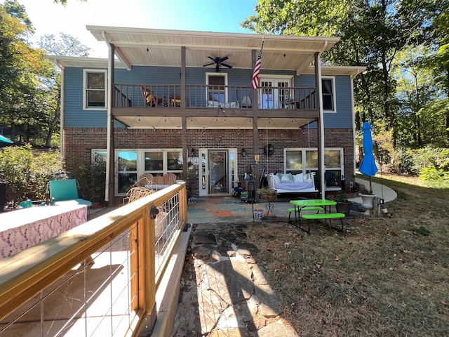 rear view of house featuring ceiling fan, a patio area, a balcony, and french doors