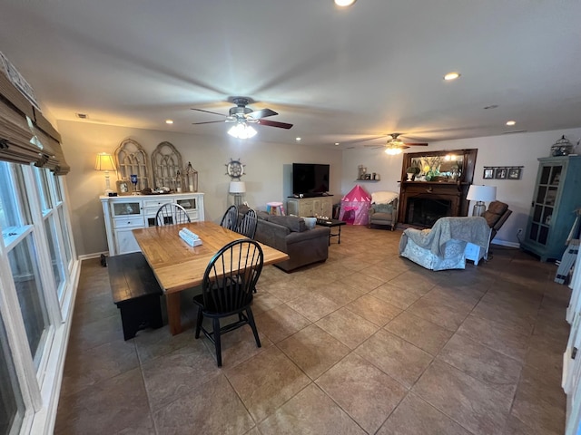 tiled dining space featuring recessed lighting, a fireplace, and ceiling fan
