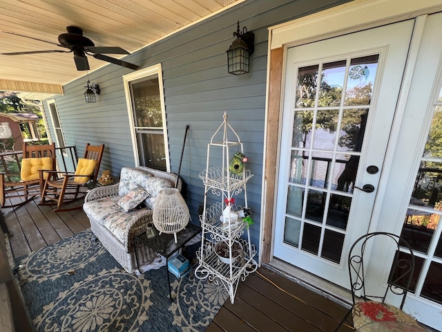 wooden terrace featuring a ceiling fan and covered porch