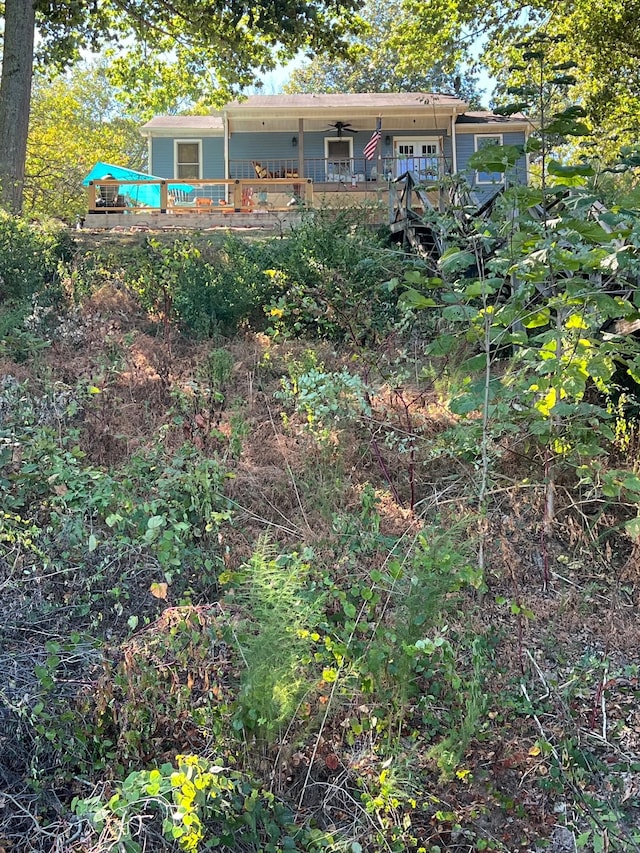 back of property featuring ceiling fan