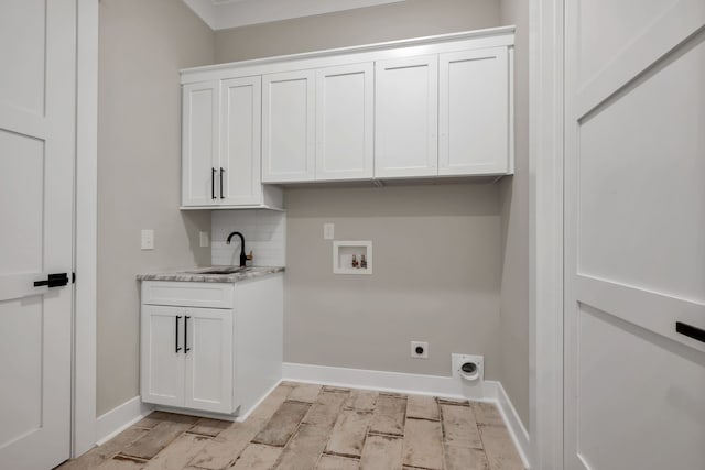 laundry area with cabinets, electric dryer hookup, hookup for a washing machine, sink, and light hardwood / wood-style floors