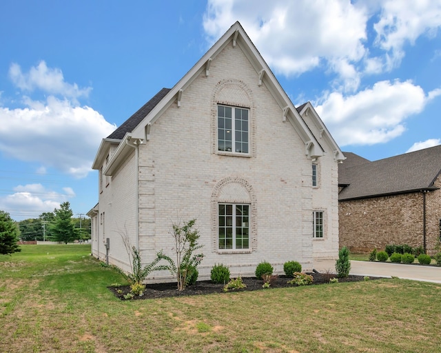 view of property exterior featuring a lawn