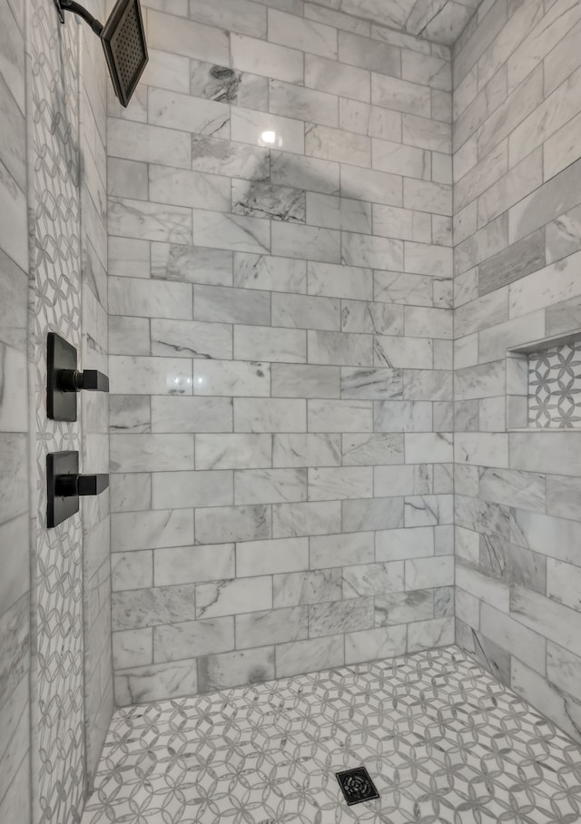 bathroom with tiled shower