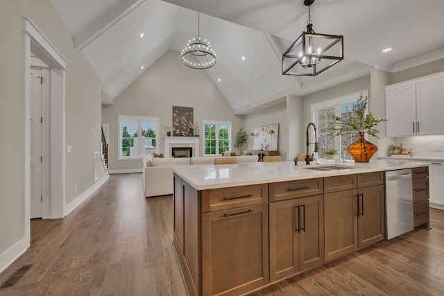 kitchen featuring a chandelier, white cabinets, and a wealth of natural light