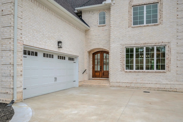 exterior space featuring a garage and french doors