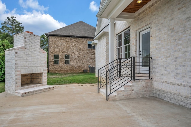 view of patio featuring cooling unit and an outdoor fireplace