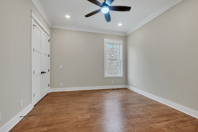 spare room with crown molding, ceiling fan, and hardwood / wood-style flooring