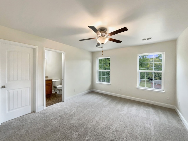 unfurnished bedroom featuring connected bathroom, ceiling fan, and carpet flooring