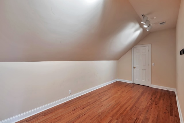 bonus room featuring hardwood / wood-style floors and vaulted ceiling