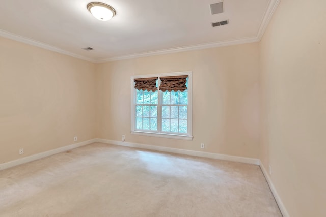 empty room featuring light colored carpet and ornamental molding