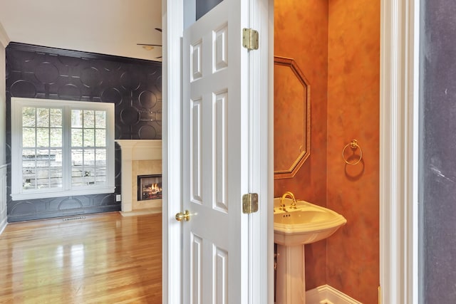 bathroom with crown molding and hardwood / wood-style floors