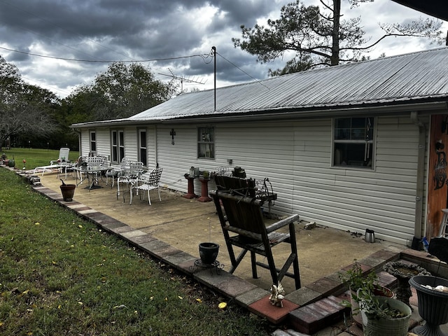 315 Loyd Rd, Pulaski, TN 38478 - back of house featuring a lawn, a metal roof, and a patio area