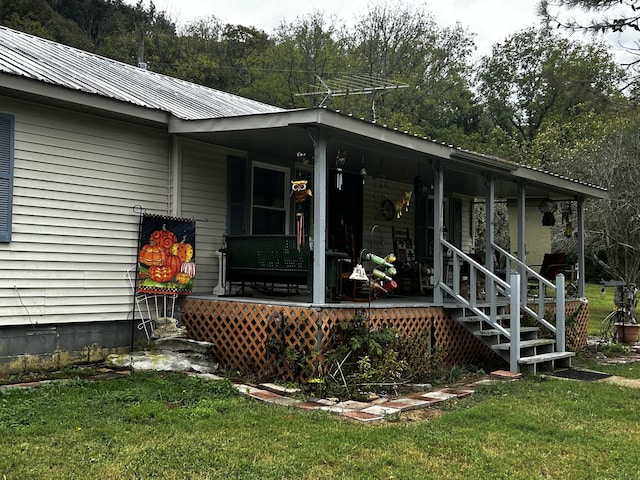 315 Loyd Rd, Pulaski, TN 38478 - view of exterior entry featuring covered porch, a yard, and a metal roof