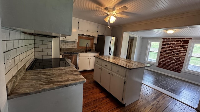 315 Loyd Rd, Pulaski, TN 38478 - kitchen with stainless steel appliances, white cabinets, dark wood-type flooring, a center island, and tasteful backsplash