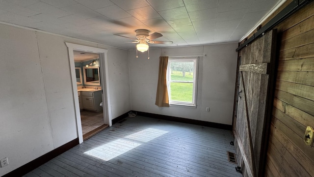 315 Loyd Rd, Pulaski, TN 38478 - unfurnished bedroom featuring wood-type flooring, a ceiling fan, and connected bathroom