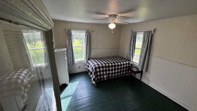 315 Loyd Rd, Pulaski, TN 38478 - bedroom featuring dark wood-type flooring, wood walls, and ceiling fan