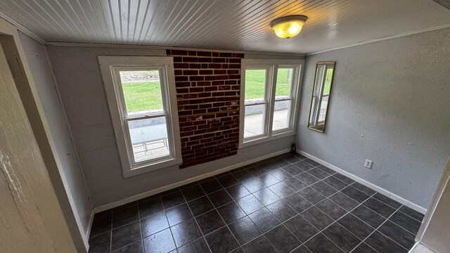 315 Loyd Rd, Pulaski, TN 38478 - empty room with plenty of natural light, dark tile patterned floors, a textured wall, and crown molding