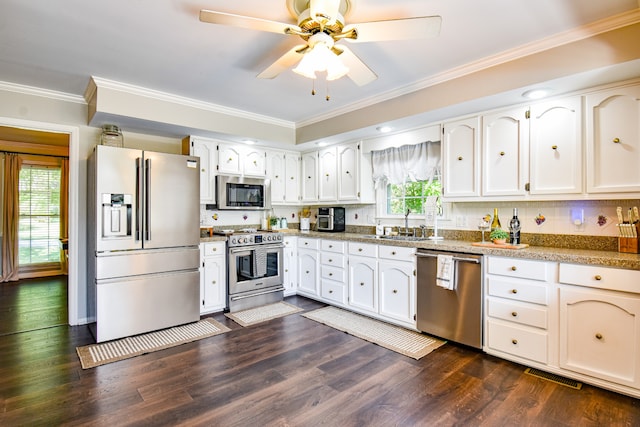 kitchen featuring a healthy amount of sunlight, dark hardwood / wood-style floors, ceiling fan, and stainless steel appliances