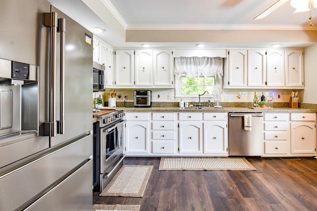 kitchen with ceiling fan, white cabinets, high quality appliances, and dark wood-type flooring