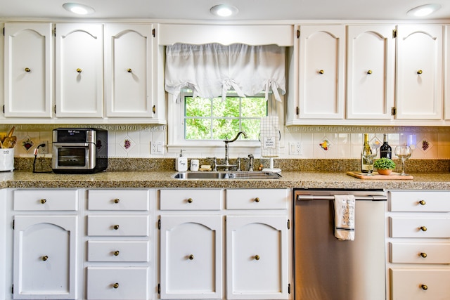 kitchen with dishwasher, sink, and white cabinetry