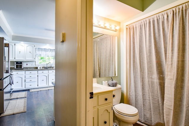 bathroom featuring ornamental molding, wood-type flooring, vanity, and toilet