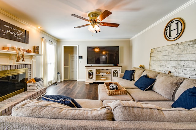 living room featuring dark wood-type flooring, ceiling fan, a fireplace, and crown molding