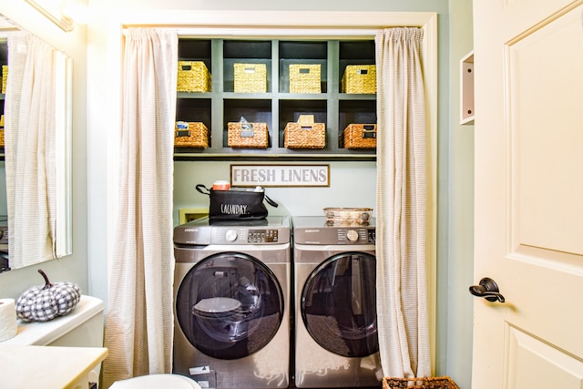 clothes washing area featuring washing machine and dryer