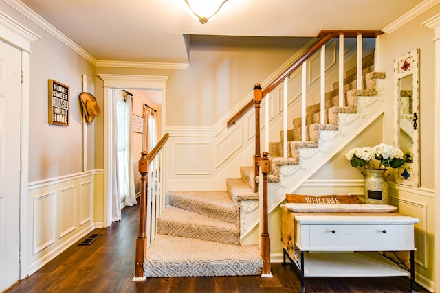 staircase featuring ornamental molding and hardwood / wood-style floors