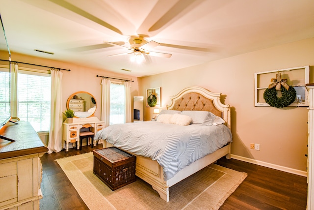 bedroom with dark hardwood / wood-style floors and ceiling fan