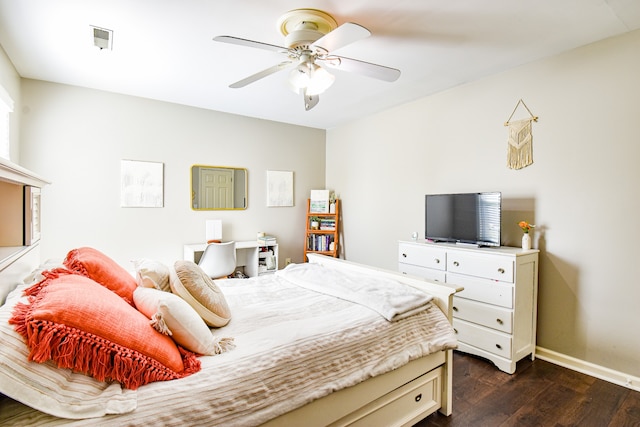 bedroom with dark hardwood / wood-style flooring and ceiling fan