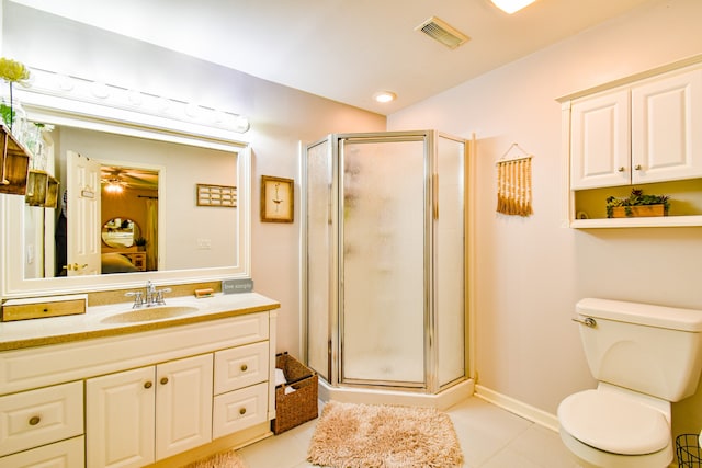 bathroom featuring vanity, toilet, an enclosed shower, and tile patterned floors